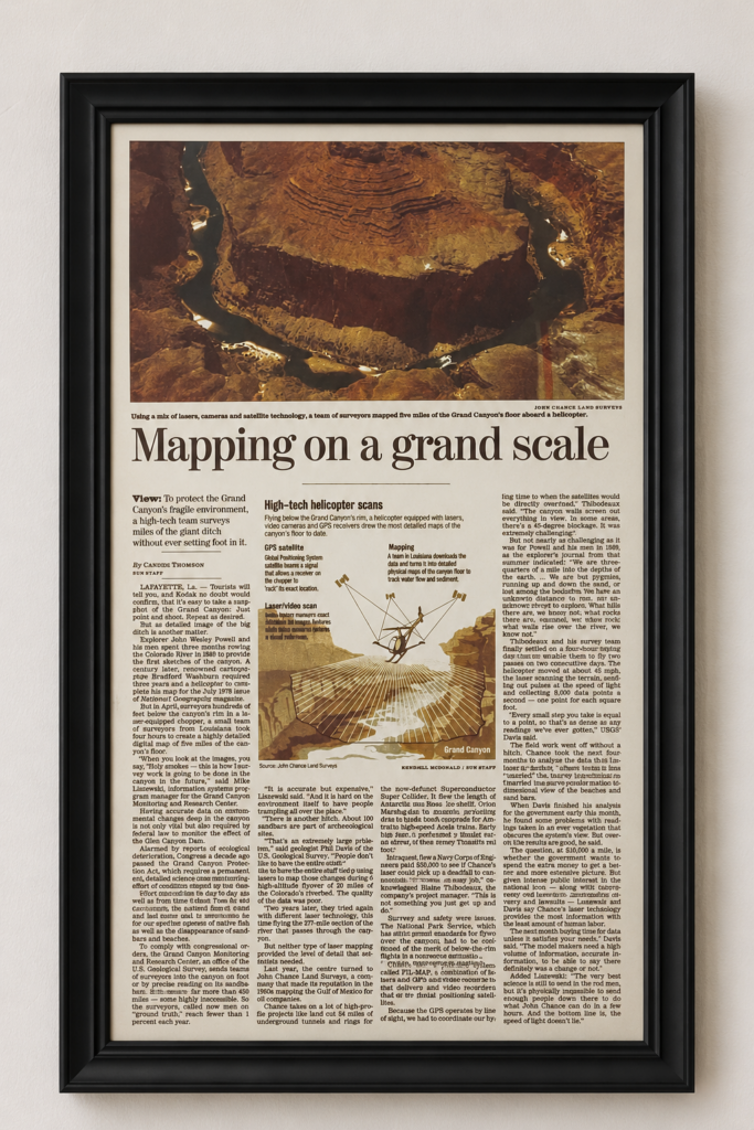 Framed newspaper article titled “Mapping on a grand scale” about using our FLI-MAP helicopter mounted laser scanning, cameras, and satellite technology to map the Grand Canyon.